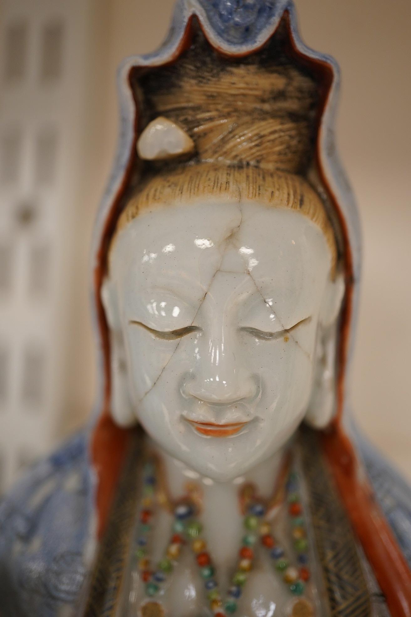 A Chinese enamelled porcelain group of Guanyin holding a child, Qianlong period